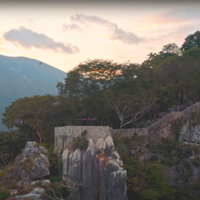 DJ playing on top of cliff